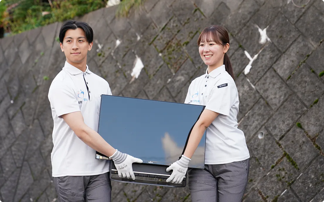 ゴミ屋敷タクセル東京の女性スタッフと男性スタッフが不用品のテレビを運んでいる画像